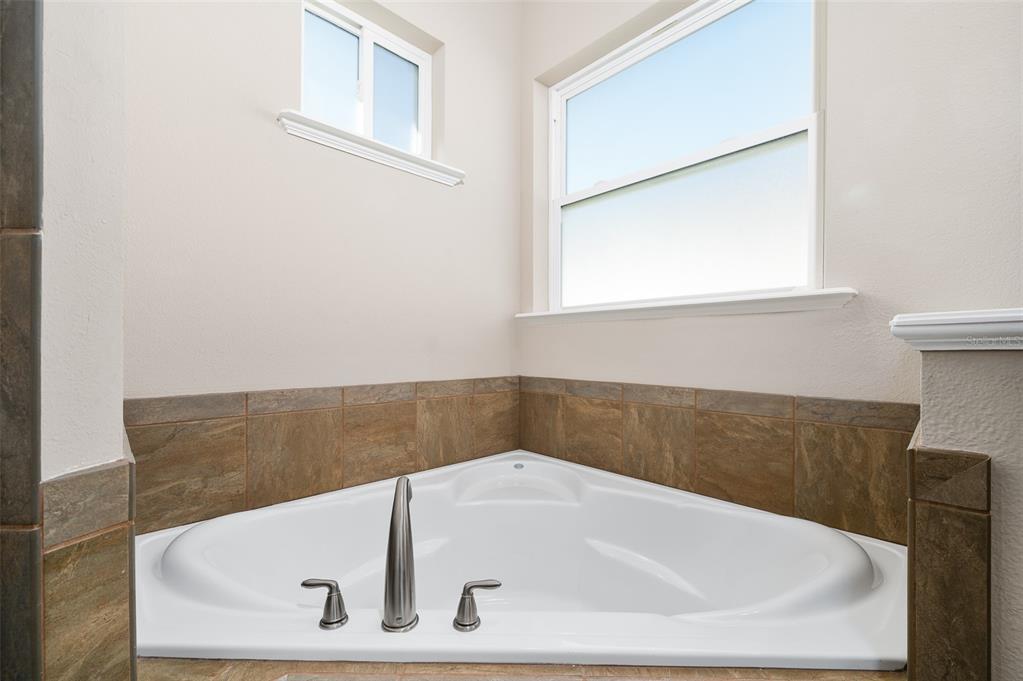 2779 Southwest 121st Drive Gainesville, FL 32608 - Photo 23 of 39 a white bath tub sitting in a bathroom