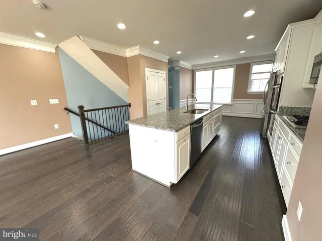a view of a livingroom with a ceiling fan and window