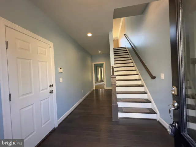 a view of entryway and hall with wooden floor