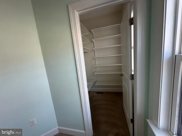 a view of an empty room with a ceiling fan