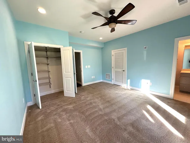 a view of a livingroom with a ceiling fan and window