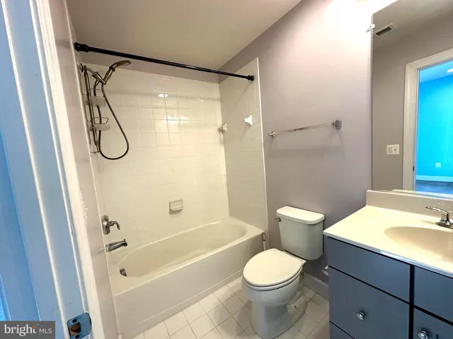 a bathroom with a granite countertop toilet sink and shower