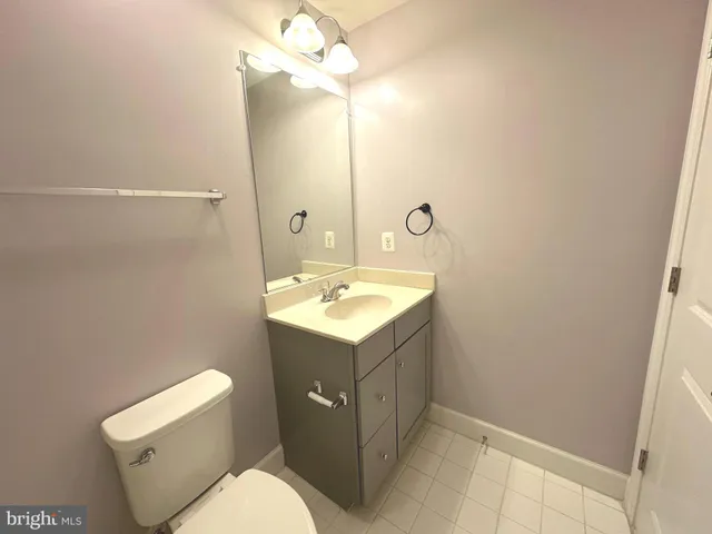 a bathroom with a sink a toilet and mirror