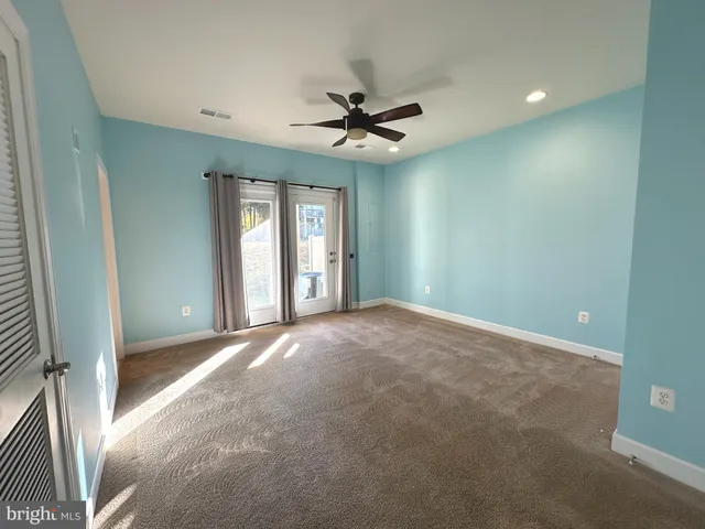 a view of a livingroom with a ceiling fan and window
