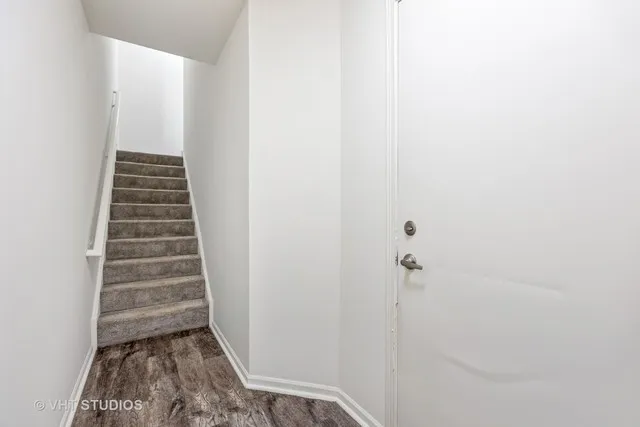 a view of a hallway with stairs and rack