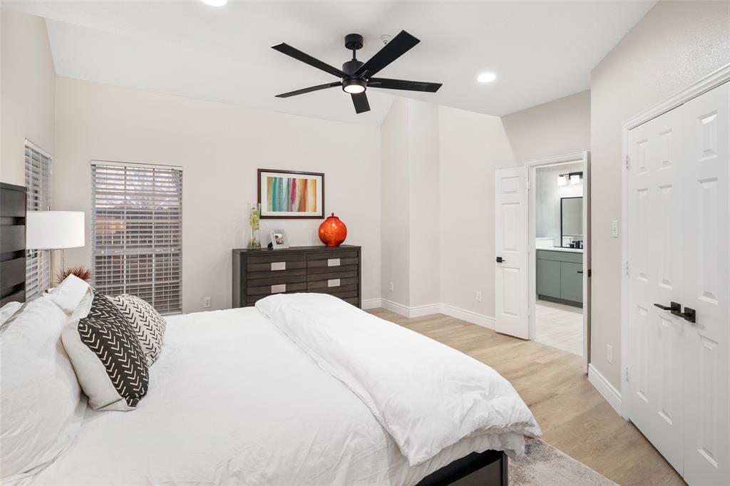 14604 Hemingway Court Addison, TX 75001 - Photo 10 of 27 a bedroom with a bed and a chandelier