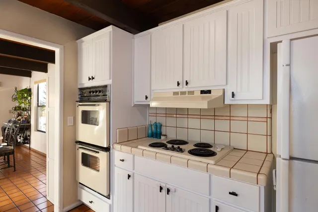 a kitchen with a stove and a refrigerator