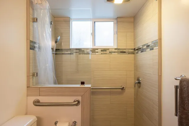 a bathroom with a shower and a toilet