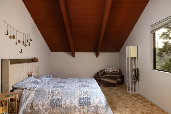 a bedroom with a bed and a window