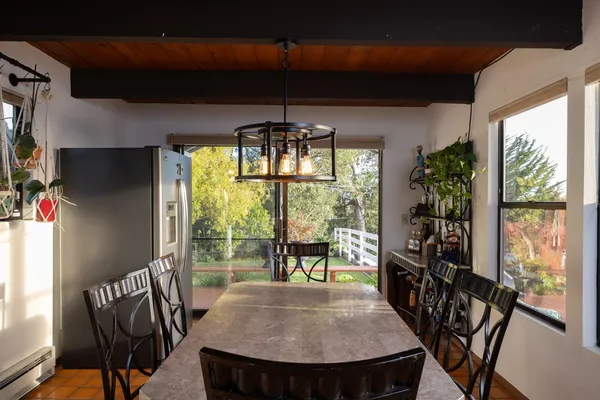 a view of a dining room with furniture window and outside view