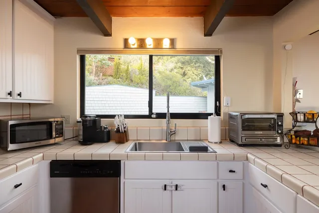 a kitchen with a stove a sink and a microwave