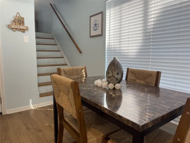 a dining room with furniture and wooden floor