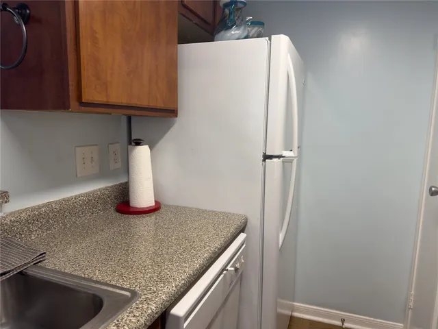 a kitchen with a sink and a refrigerator