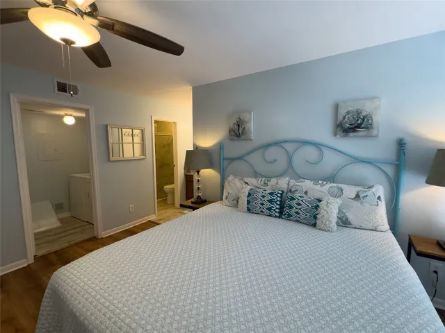 a bedroom with a large bed and a chandelier