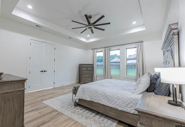 a bedroom with a large bed and a window