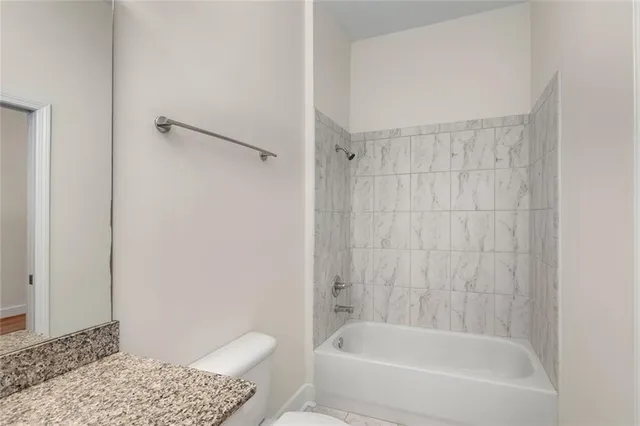 a view of kitchen with stainless steel appliances refrigerator stove microwave and cabinets