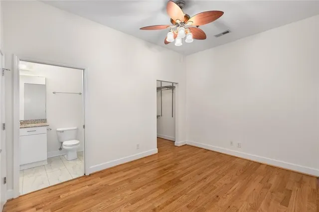 a patio with a table and chairs and potted plants