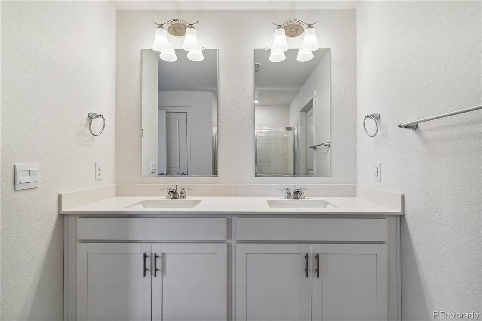 2219 Crosswind Street Fort Lupton, CO 80621 - Photo 21 of 34 a bathroom with a sink and a mirror