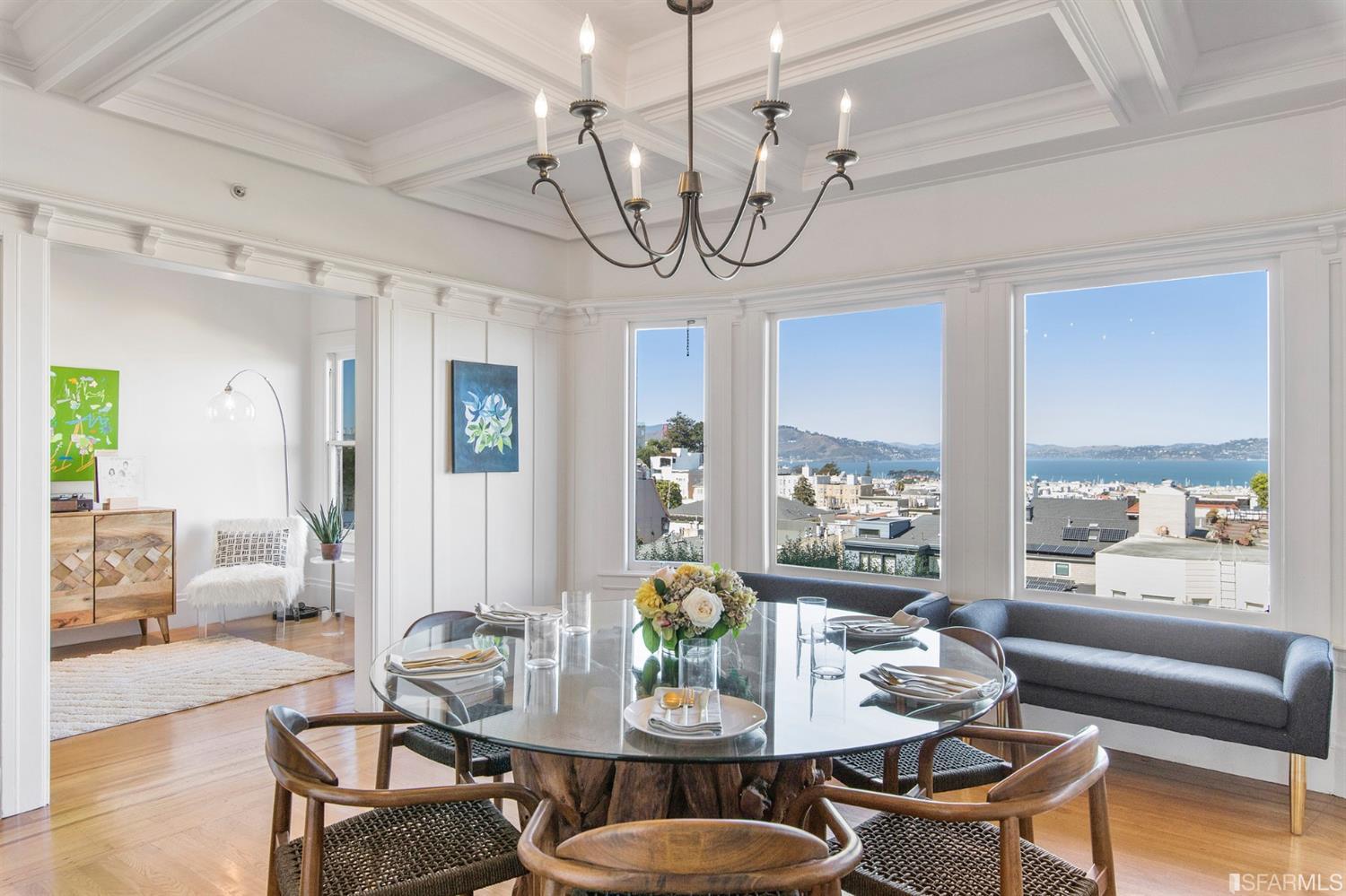 a view of a dining room with furniture wooden floor and chandelier