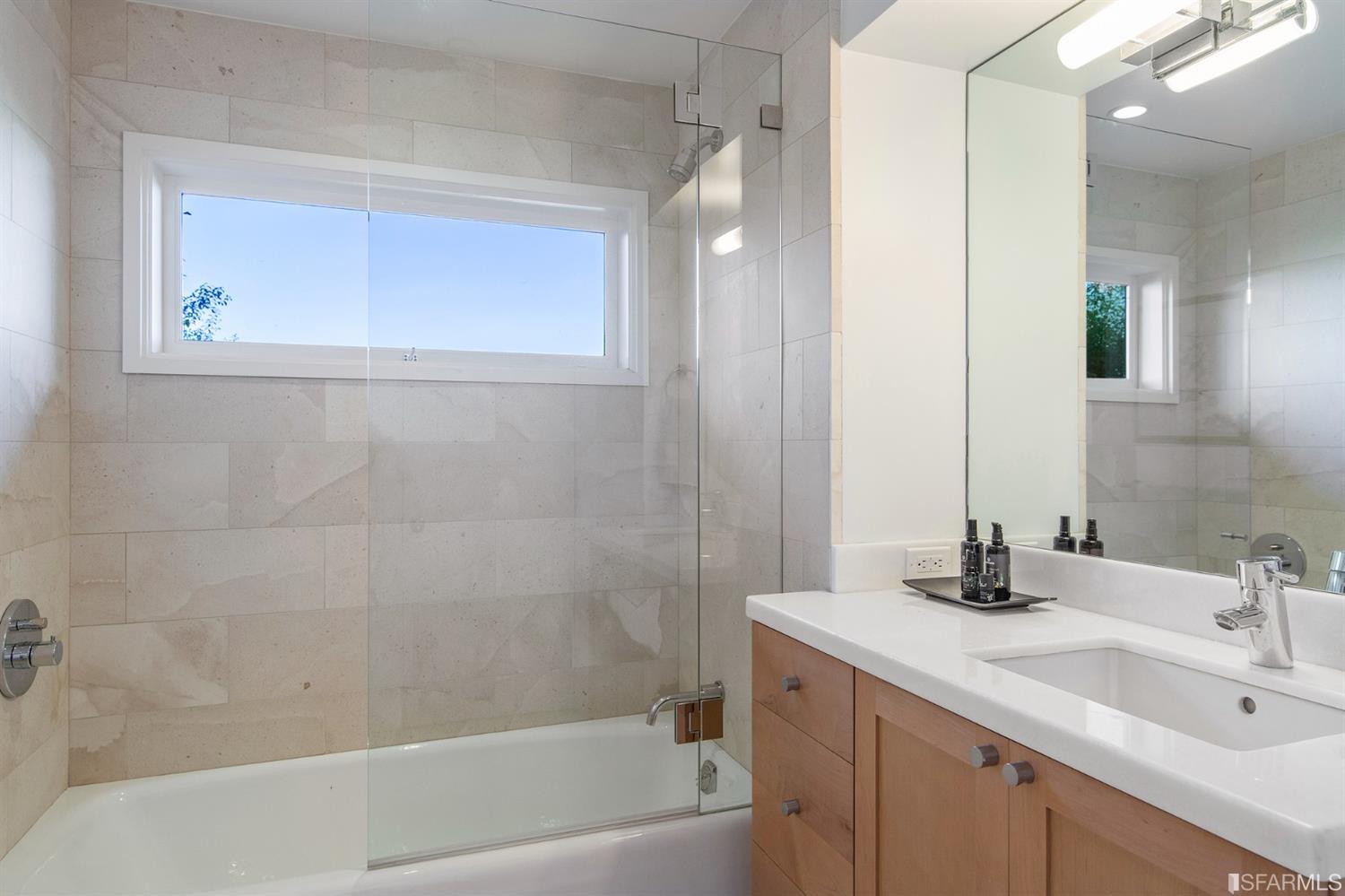 2444 Broadway San Francisco, CA 94115 - Photo 40 of 57 a bathroom with a bathtub shower sink vanity and a mirror