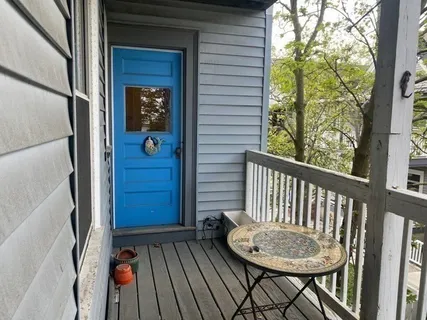 a view of a balcony with a table and chairs