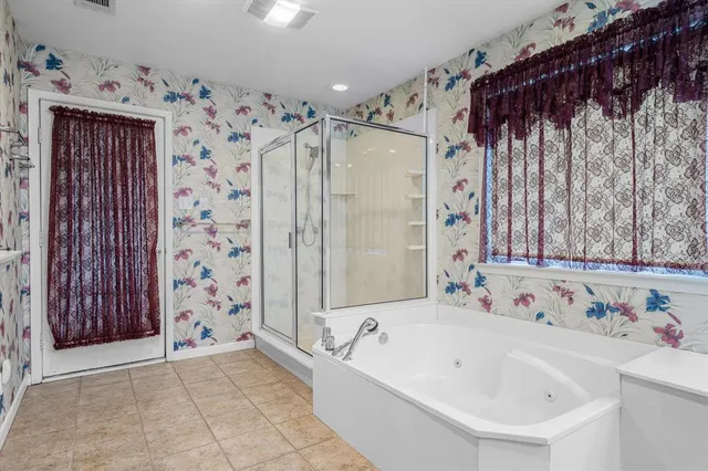 a bathroom with a bathtub and shower