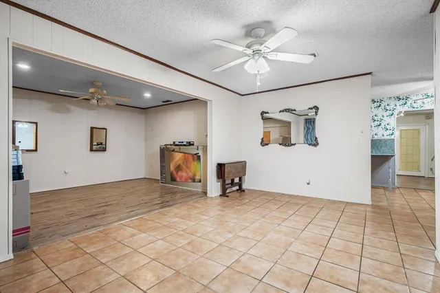 a view of a livingroom with a ceiling fan and window