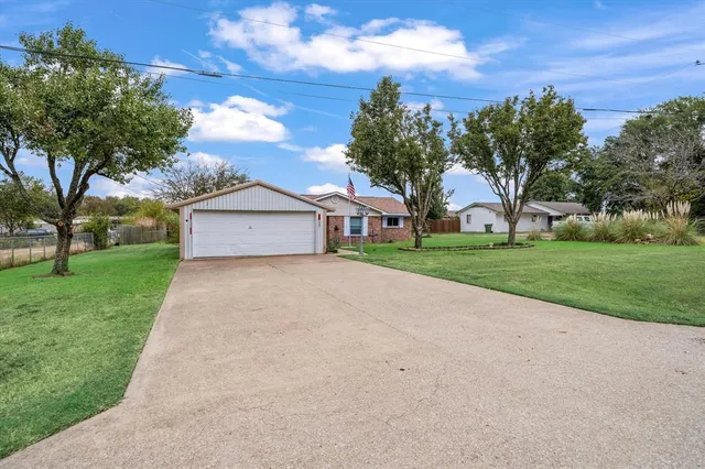 a front view of house with yard and green space