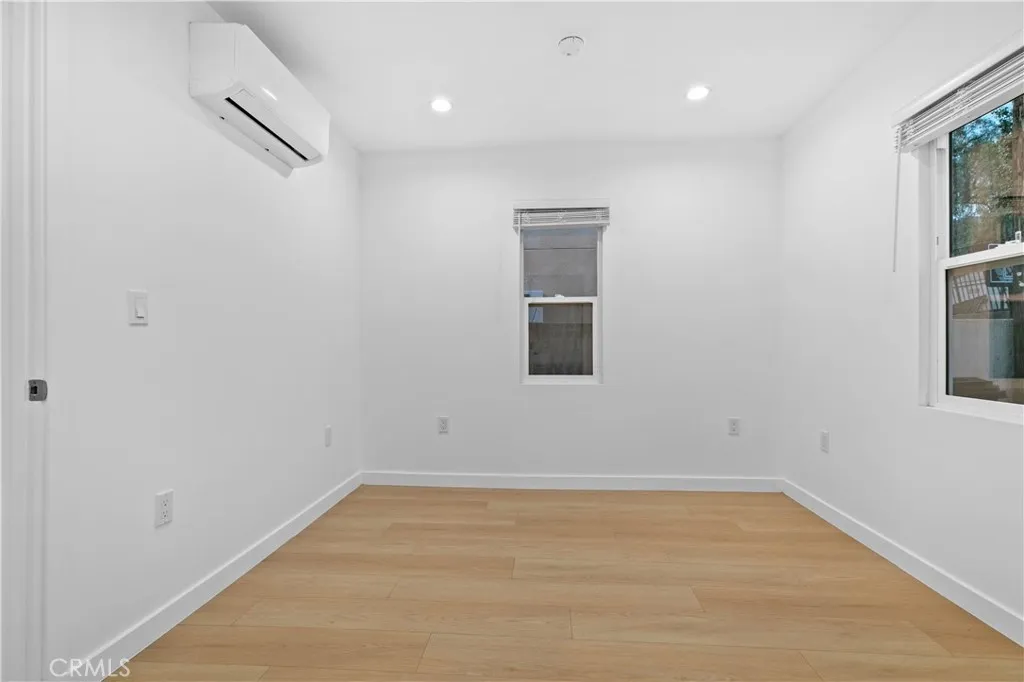 10112 Fernglen Avenue Tujunga, CA 91042 - Photo 5 of 12 a view of a room with wooden floor and windows