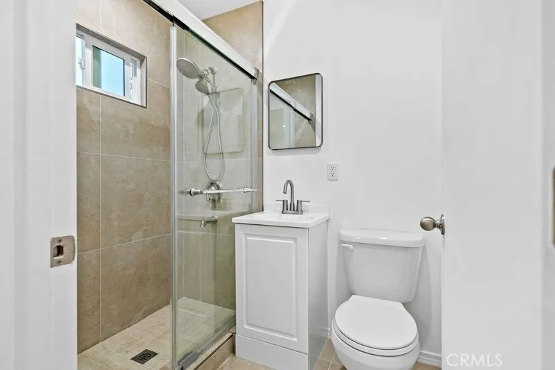 10112 Fernglen Avenue Tujunga, CA 91042 - Photo 7 of 12 a bathroom with a toilet a sink and shower