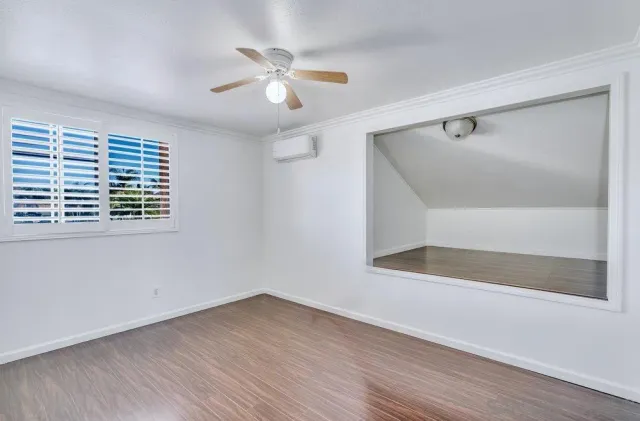 wooden floor in an empty room with a window