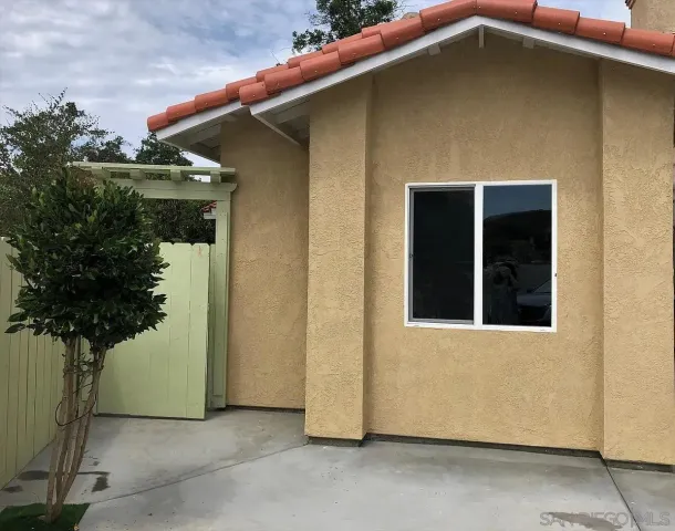 a view of a pathway of house with wooden stairs