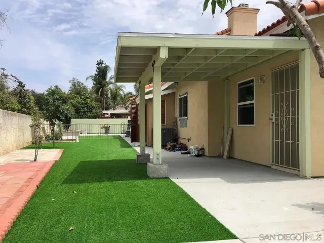 a kitchen with granite countertop a refrigerator stove and sink