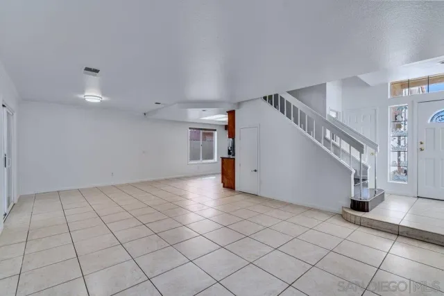 a living room with furniture a rug and a flat screen tv