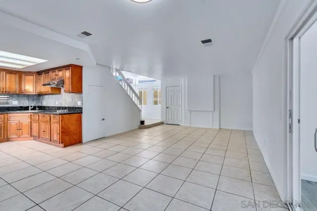 a kitchen with stainless steel appliances granite countertop a refrigerator a stove and a sink with granite countertops