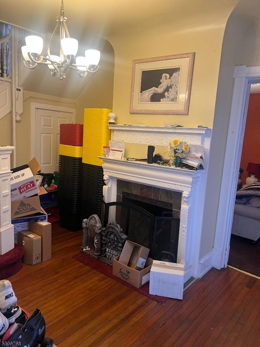 292 Spring Street Trenton, NJ 08618 - Photo 3 of 8 a living room with furniture and a fireplace