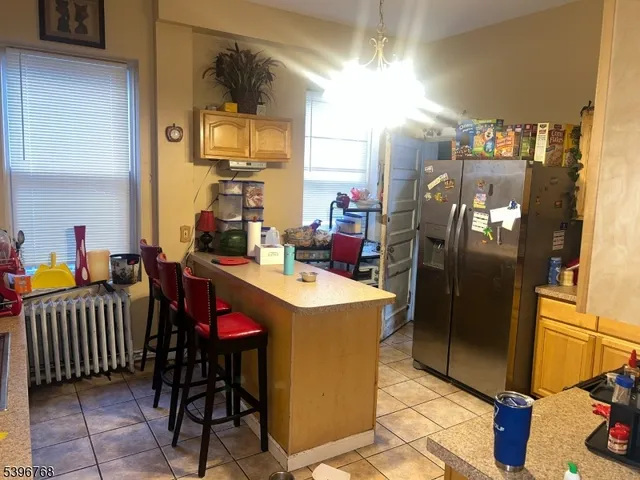 a kitchen that has a lot of cabinets and refrigerator in it
