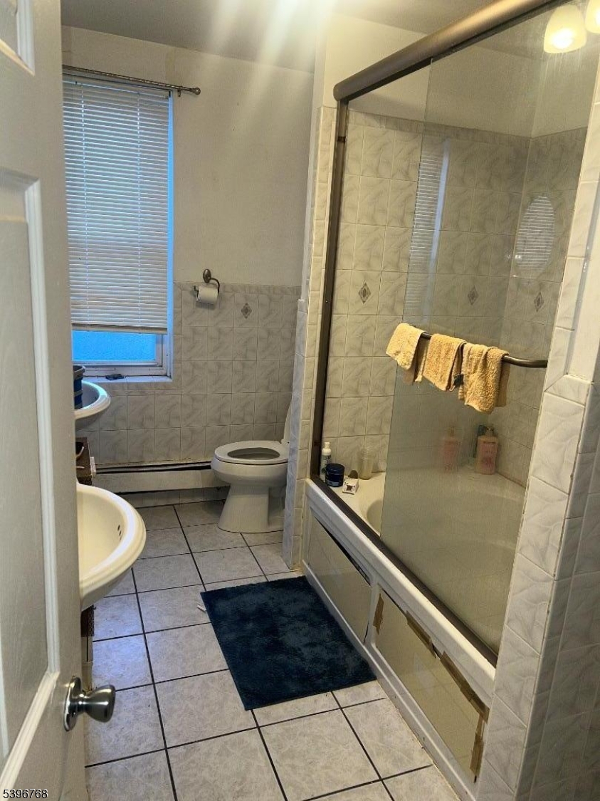 292 Spring Street Trenton, NJ 08618 - Photo 6 of 8 a bathroom with a granite countertop bathtub shower and toilet