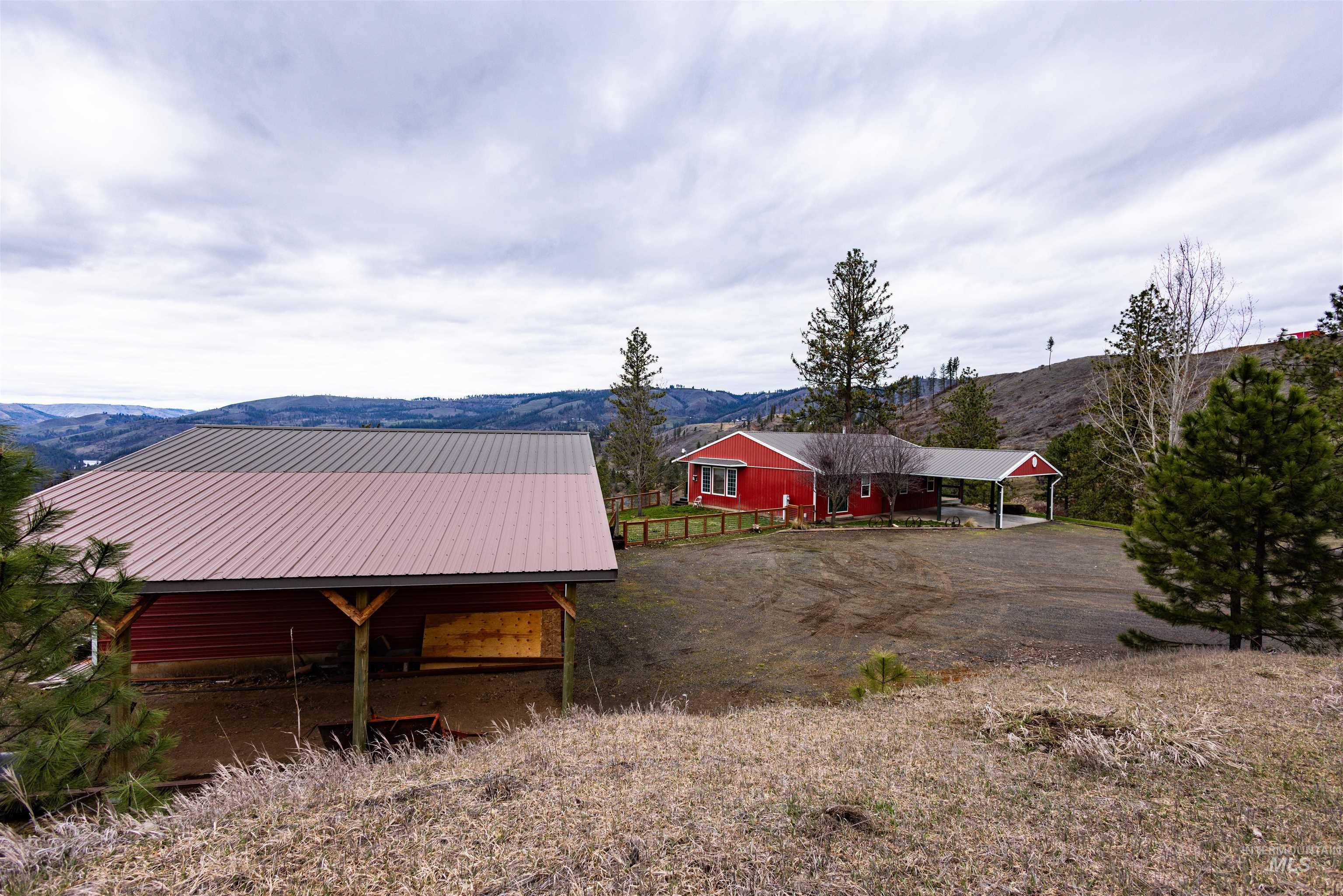 402 Beaverslide Road Kamiah, ID 83536 - Photo 24 of 46 View of yard featuring a mountain view, an outbuilding, and a rural view