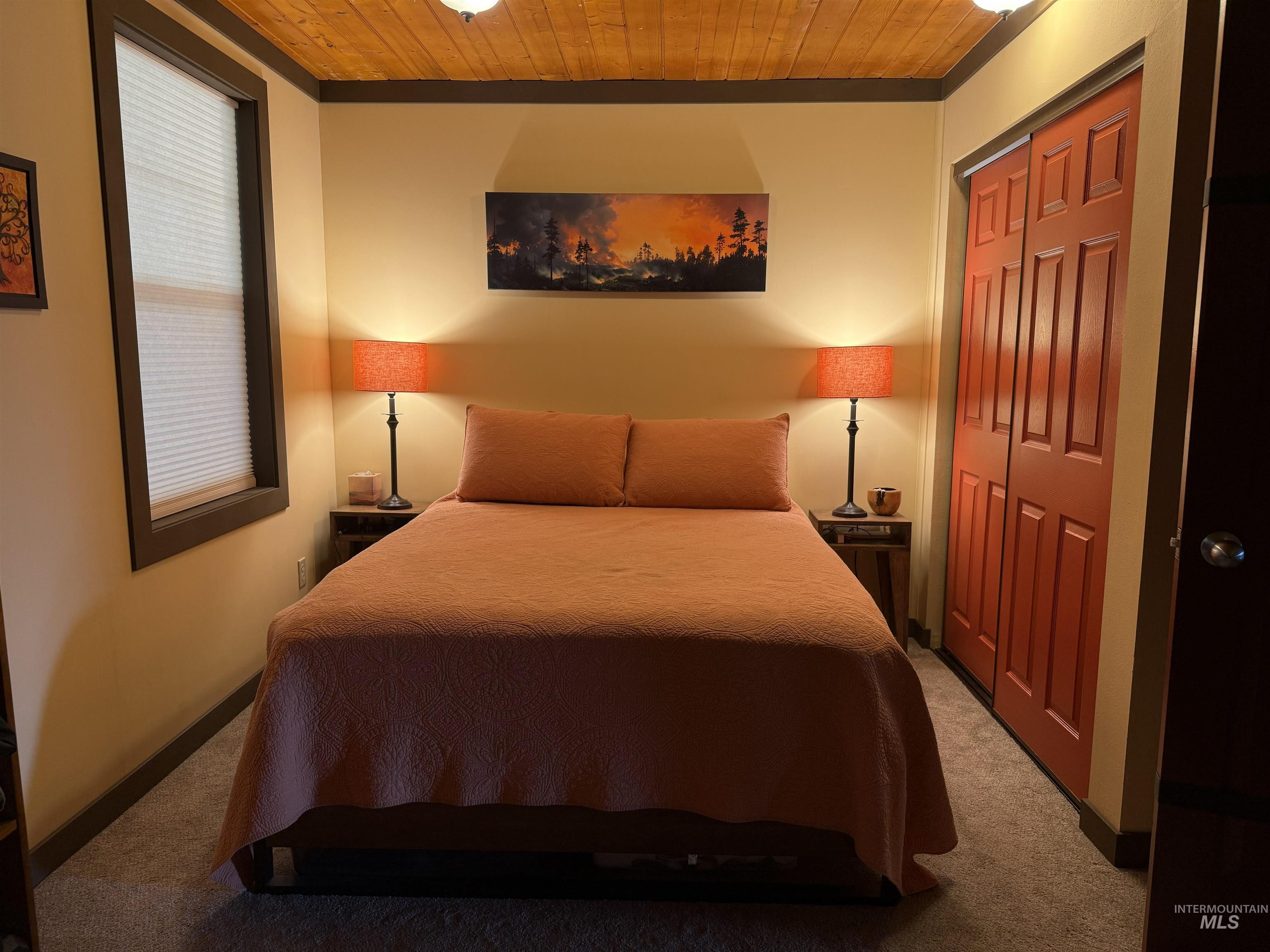 402 Beaverslide Road Kamiah, ID 83536 - Photo 25 of 46 Bedroom with wood ceiling, a closet, and carpet floors