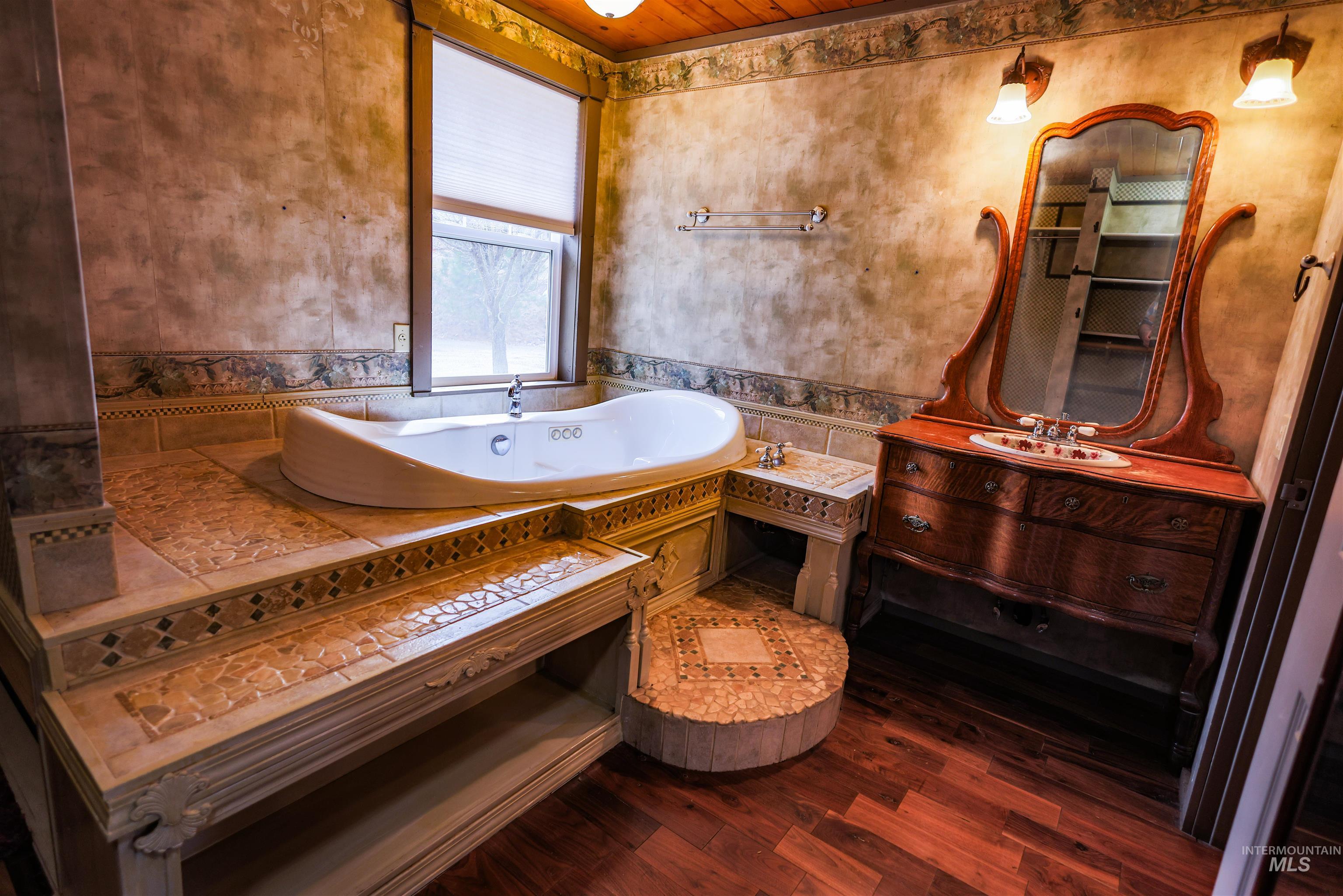402 Beaverslide Road Kamiah, ID 83536 - Photo 28 of 46 Bathroom featuring vanity, dark wood finished floors, and a bath