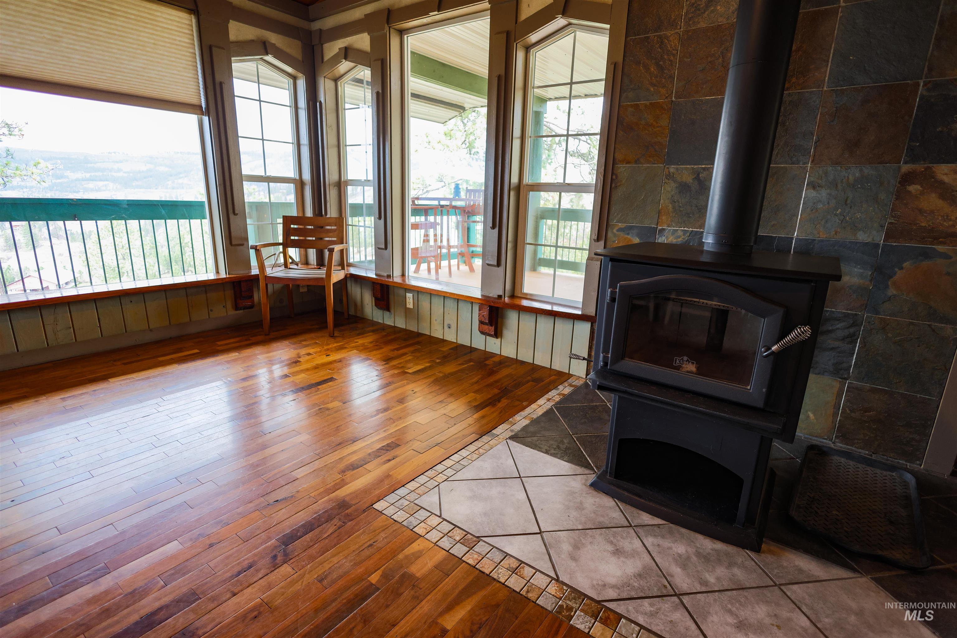 402 Beaverslide Road Kamiah, ID 83536 - Photo 29 of 46 Living area featuring a wood stove and hardwood / wood-style floors