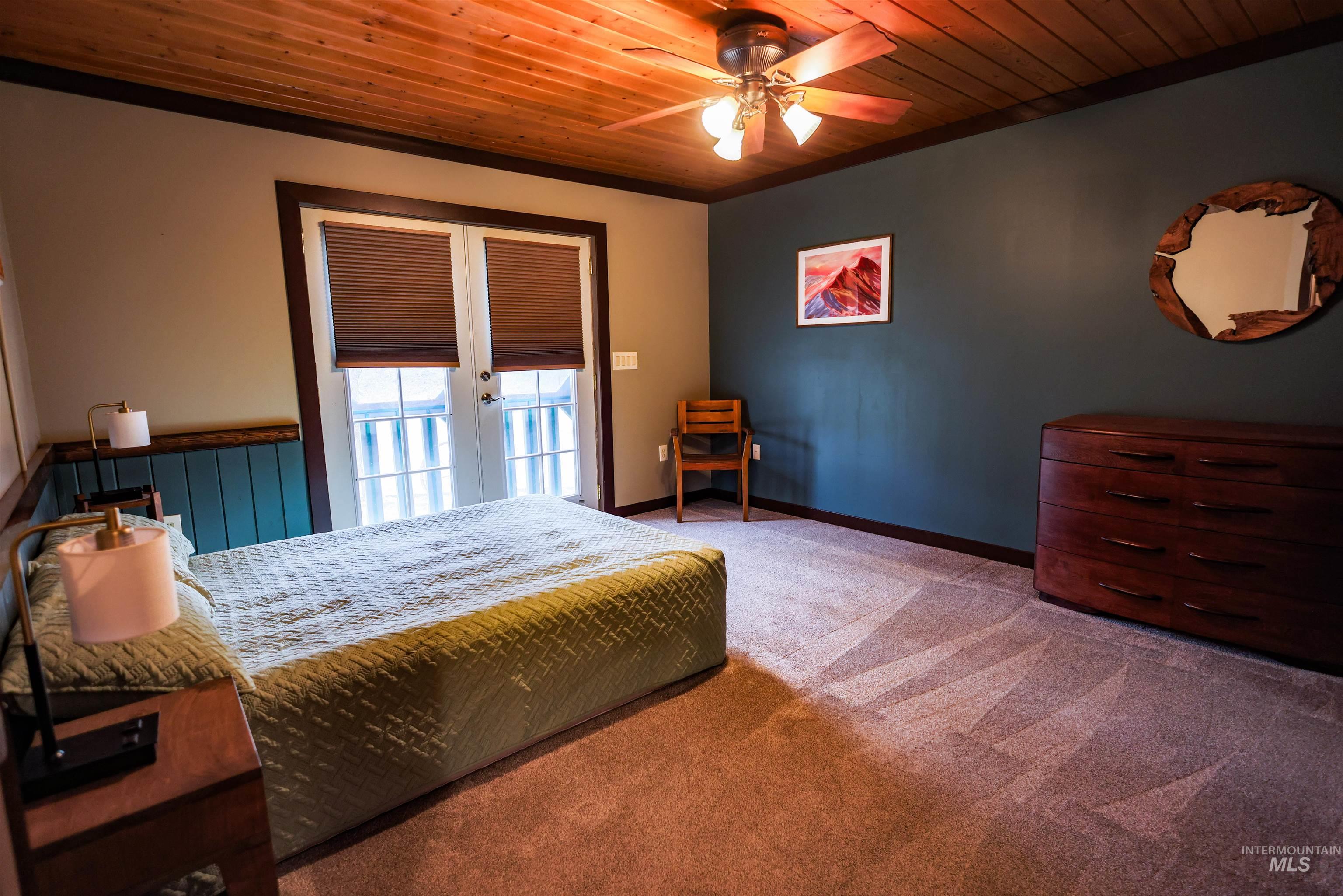 402 Beaverslide Road Kamiah, ID 83536 - Photo 31 of 46 Bedroom featuring wood ceiling, light colored carpet, and ceiling fan