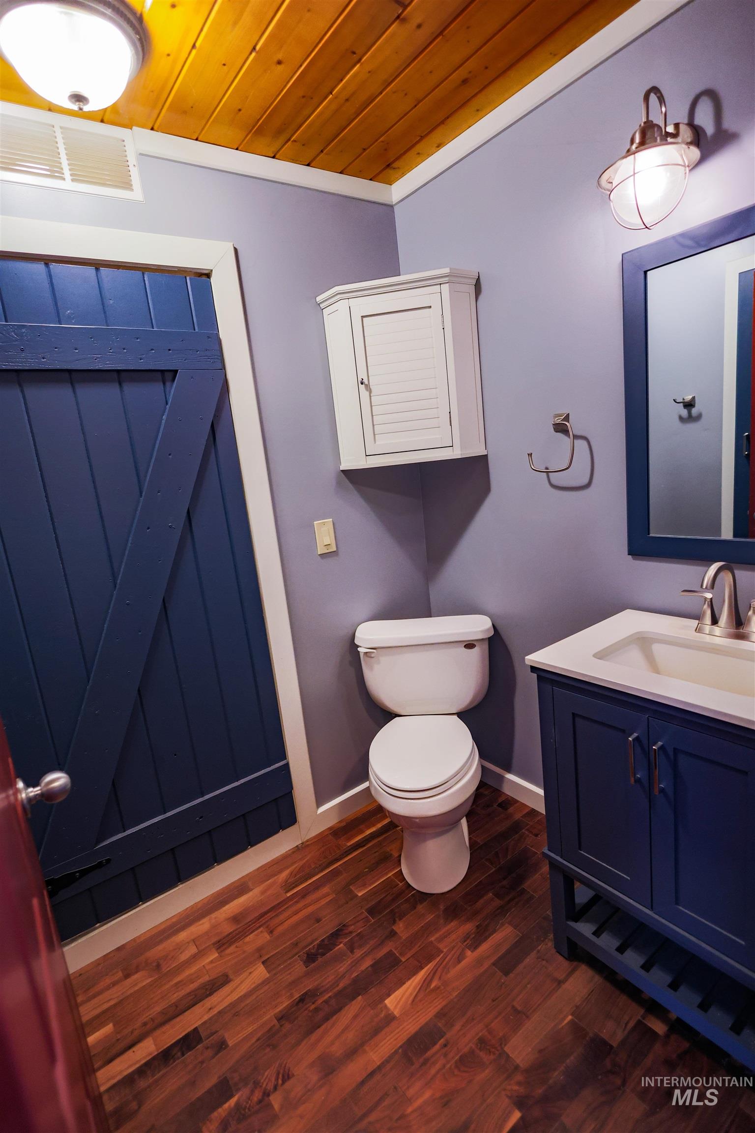 402 Beaverslide Road Kamiah, ID 83536 - Photo 33 of 46 Bathroom with vanity, dark wood finished floors, wooden ceiling, and crown molding