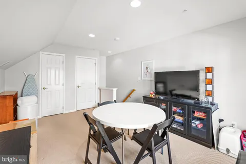 a dining room with furniture and a flat screen tv