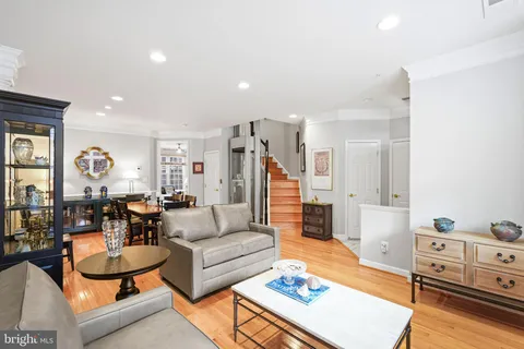a living room with furniture and wooden floor