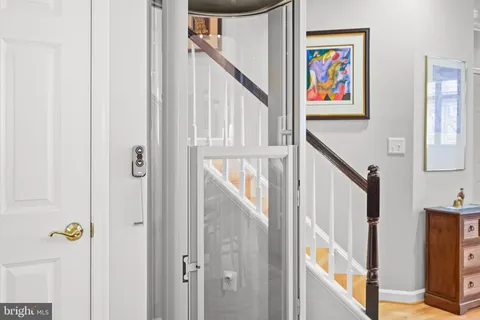 a view of an entryway with painting and stairs