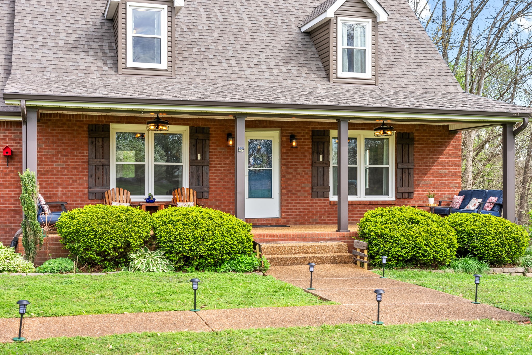 4813 Henry Gower Road Pleasant View, TN 37146 - Photo 3 of 49 a view of a brick house with a yard plants and a table and chairs