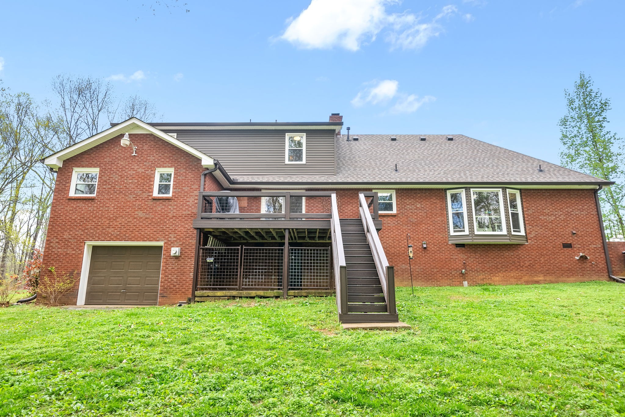 4813 Henry Gower Road Pleasant View, TN 37146 - Photo 31 of 49 a front view of a house with a yard and garage