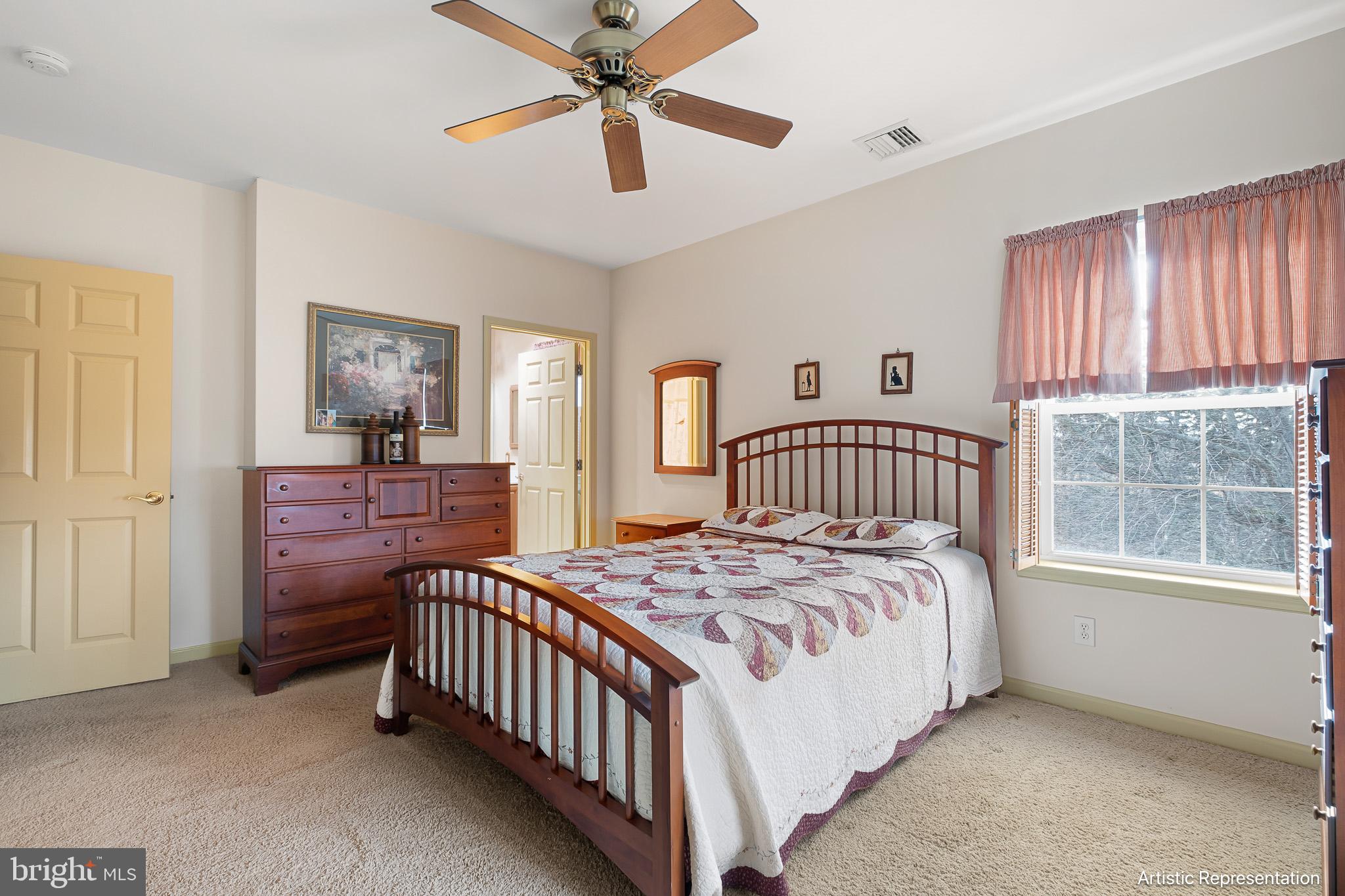 1515 Rockland Road, Unit 301 Wilmington, DE 19803 - Photo 17 of 49 a bedroom with a bed and a chandelier
